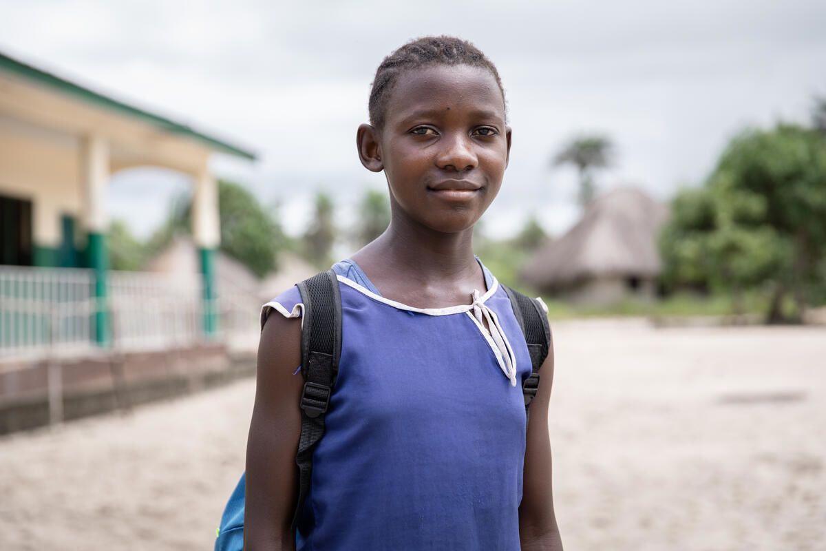 A portrait of Tenneh, aged 13, outside her school in Pujehun district, Sierra Leone.